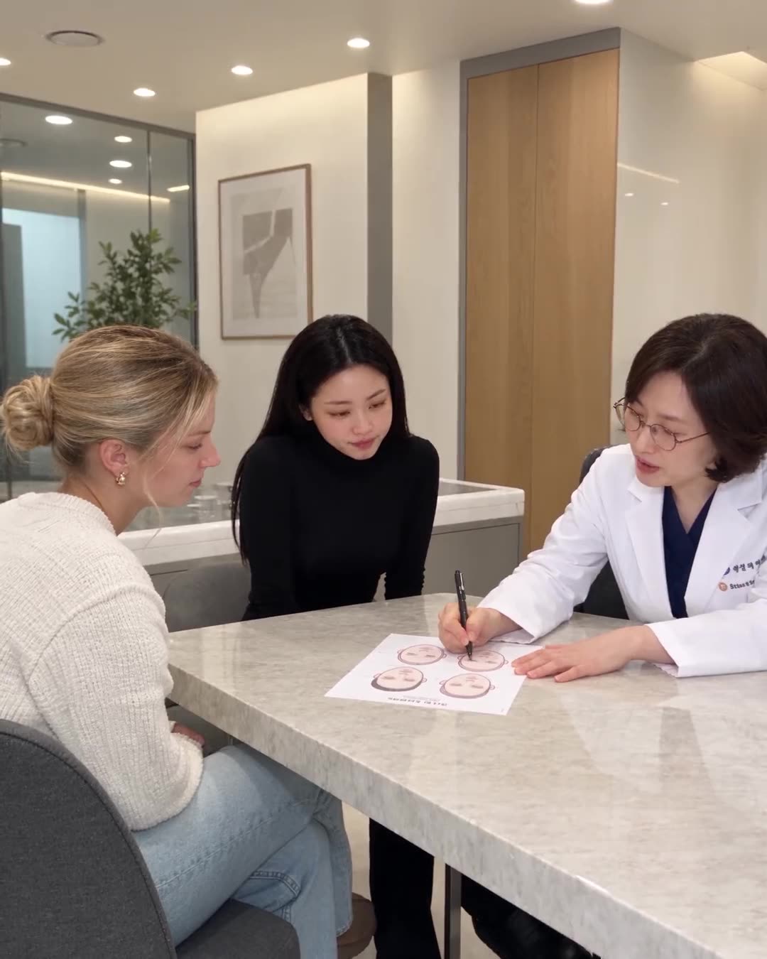 A Beautrek coordinator with a client at a Seoul clinic consultation